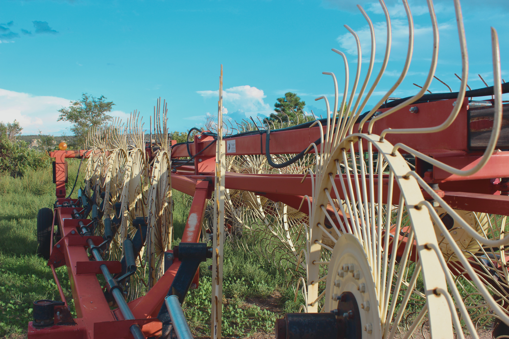 Hay rake beneath a blue sky